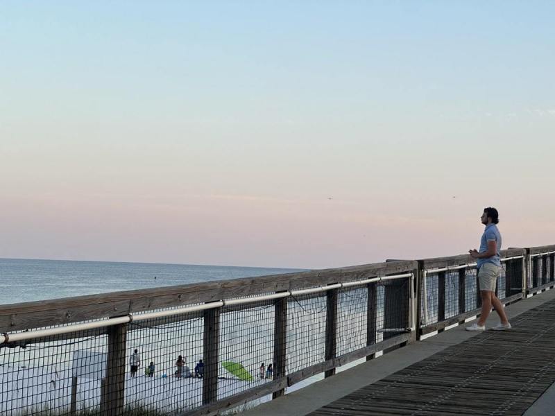 man-taking-evening-photos-on-navarre-beach-pier