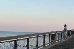 man-taking-evening-photos-on-navarre-beach-pier