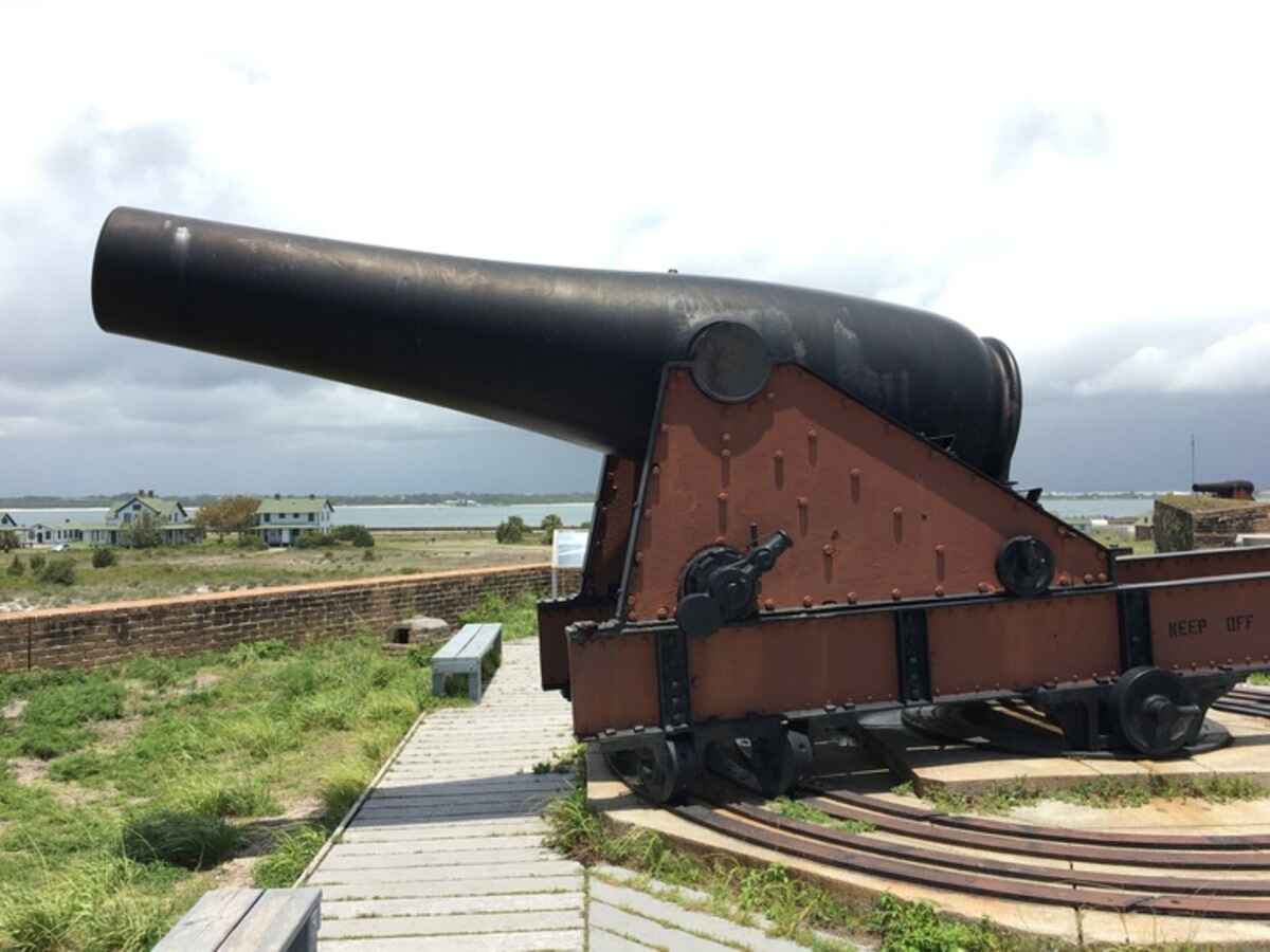 View of a large cannon on top of a brick building at fort pickens